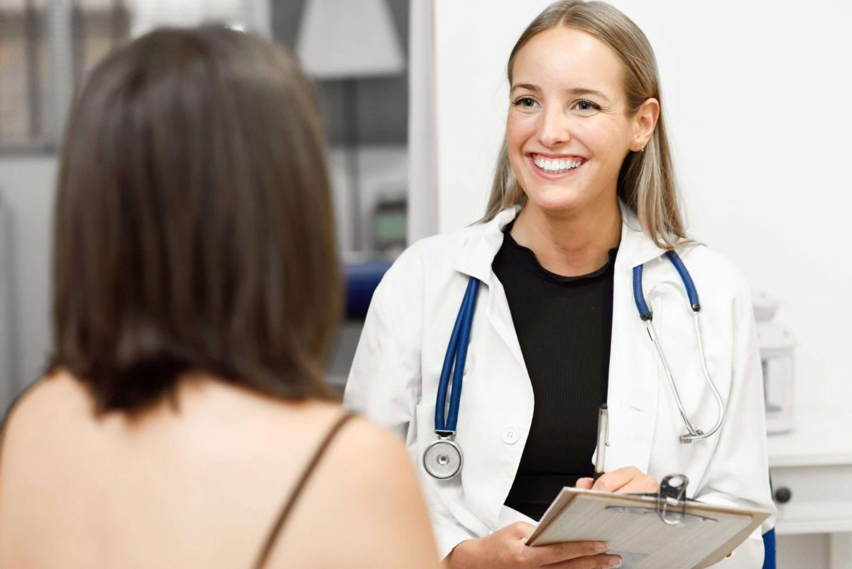 An image of a female doctor smiling at a patient whilst discussing the detoxification process.
