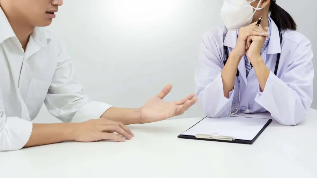 Patient talking to a Dr with a clipboard close up view of their hands