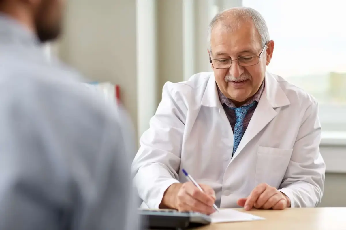 Doctor writing out a note for a patient