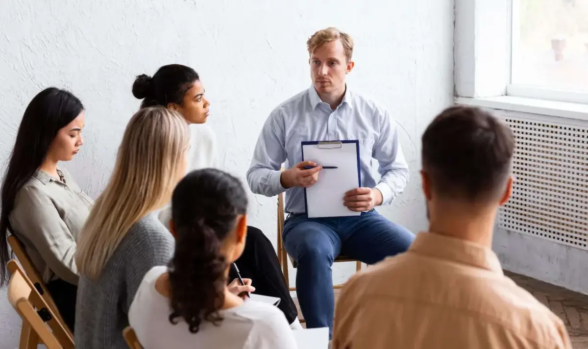 A man explains the dangers of quitting alcohol cold turkey to a group of people