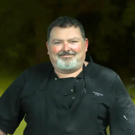 Portrait photo of Alan Greene, head chef at Smarmore Castle, photo taken outside with trees and greenery in background