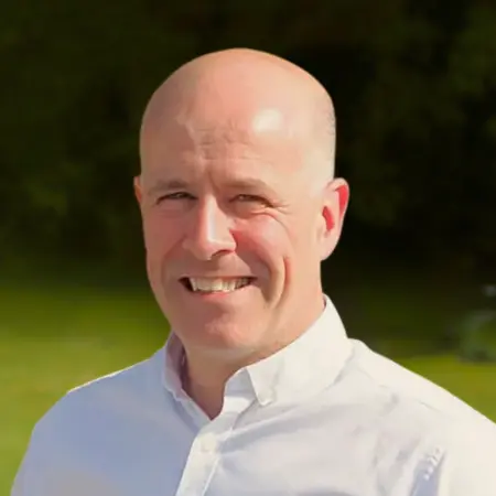 Portrait photo of David Gordon, addiction therapist at Smarmore Castle, photo taken outside with greenery and shrubs in the background