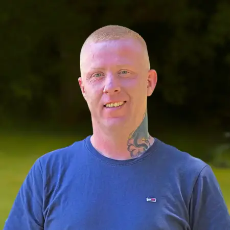 Portrait photo of David Heenery, recovery advocate at Smarmore Castle, photo taken outside against greenery