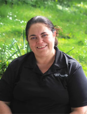 Portrait photo of Tracy Gorman, chef at Smarmore Castle, photo taken outside with greenery in the background