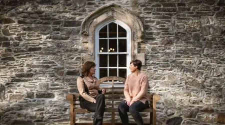 two women sitting and chatting outside of Smarmore Castle addiction clinic